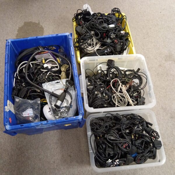 Mixed cable lot with various power supplies and network cables.