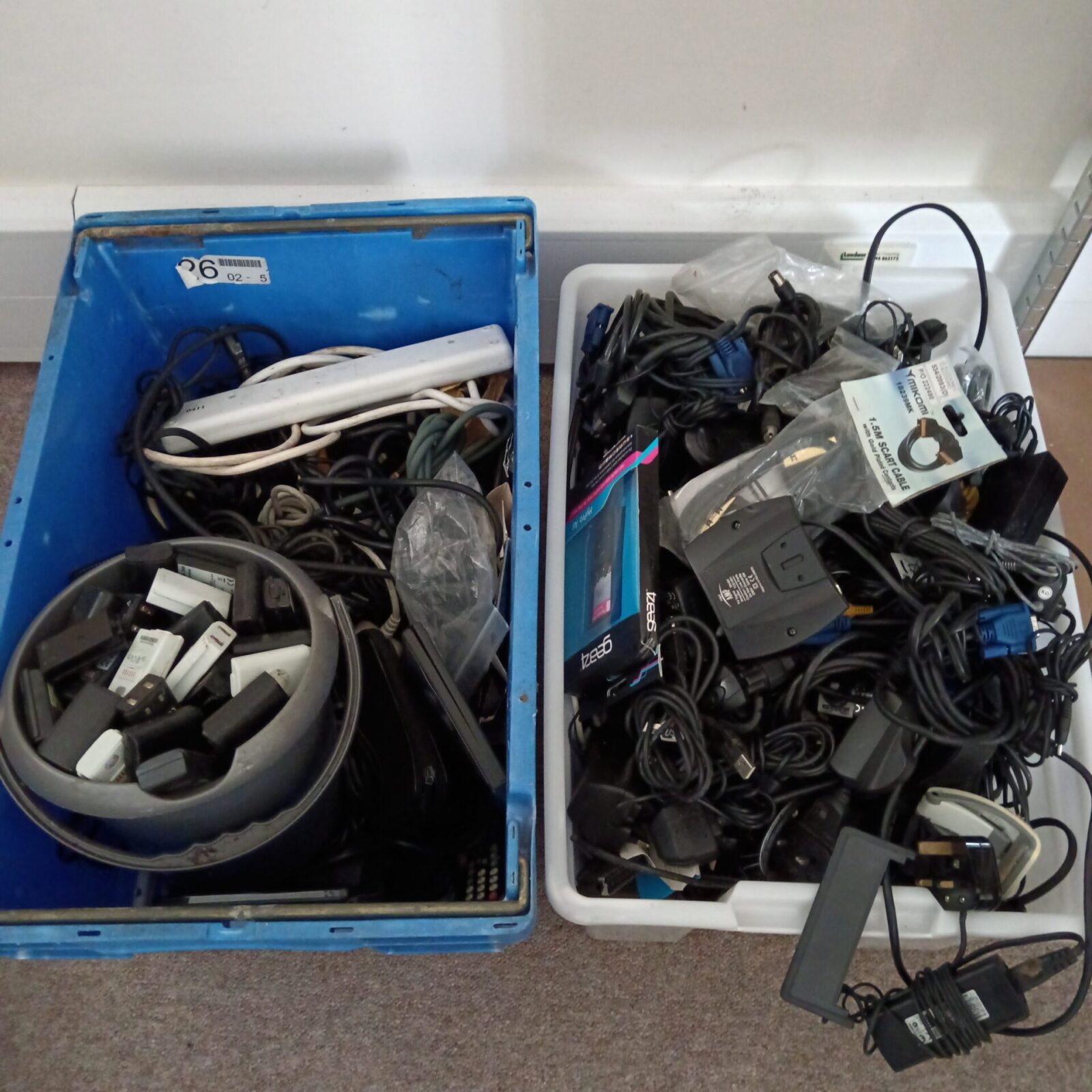 Mixed lot of cables and Xbox 360 batteries for gaming and electronics.