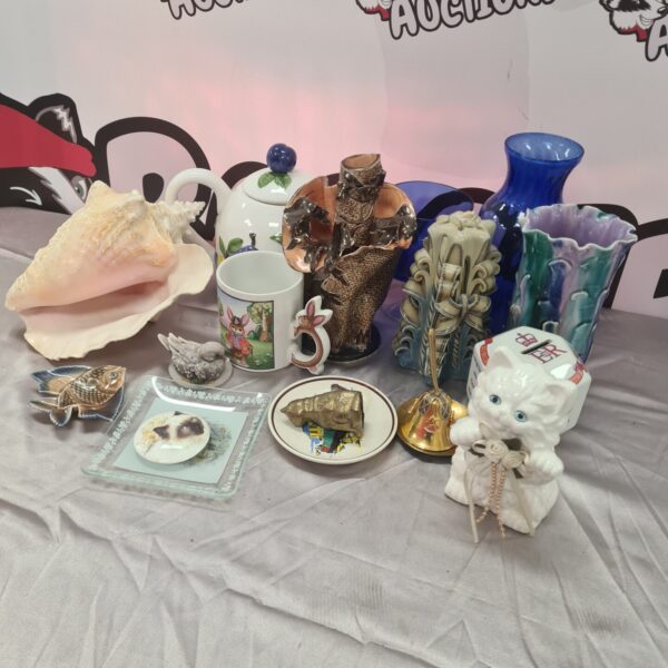 Mixed lot of vintage china and brass collectibles on display.