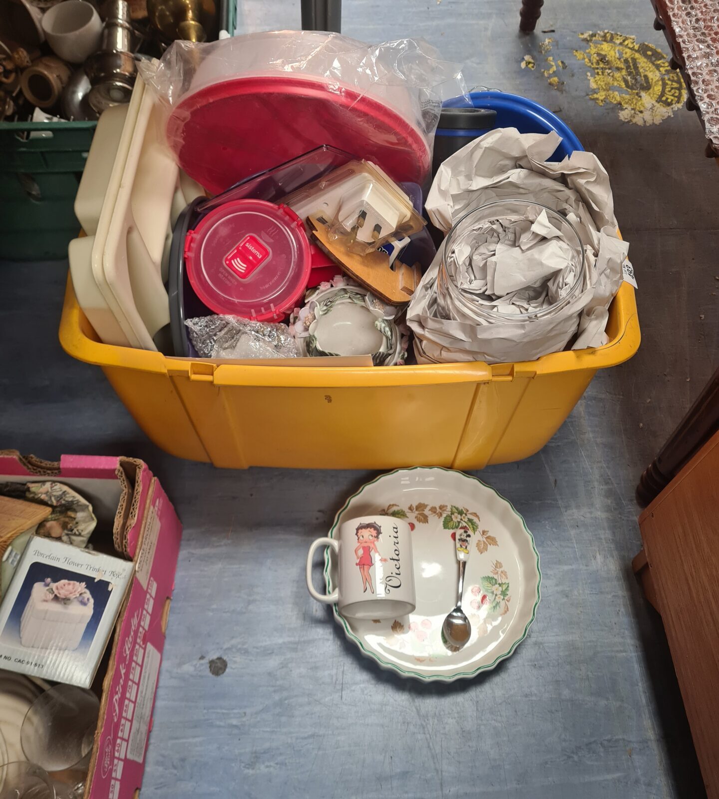 Mixed lot of vintage and modern china and dishes in a yellow container.