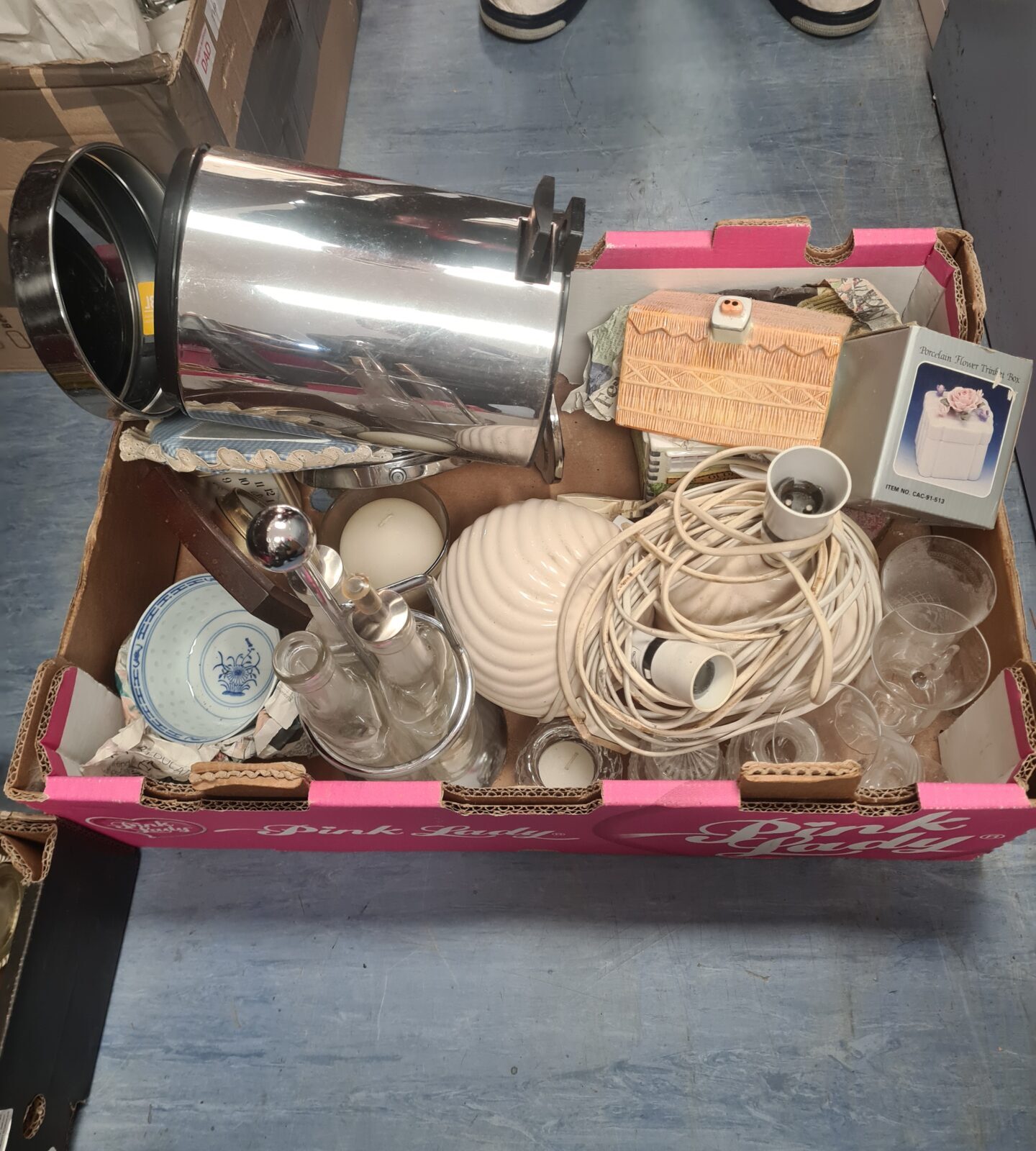 Mixed lot of vintage china, glassware, and lamps on display.