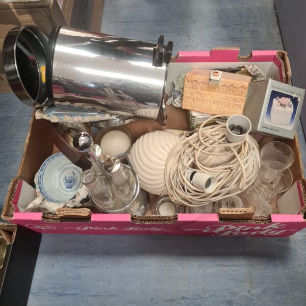 Mixed lot of vintage china, glassware, and lamps on display.