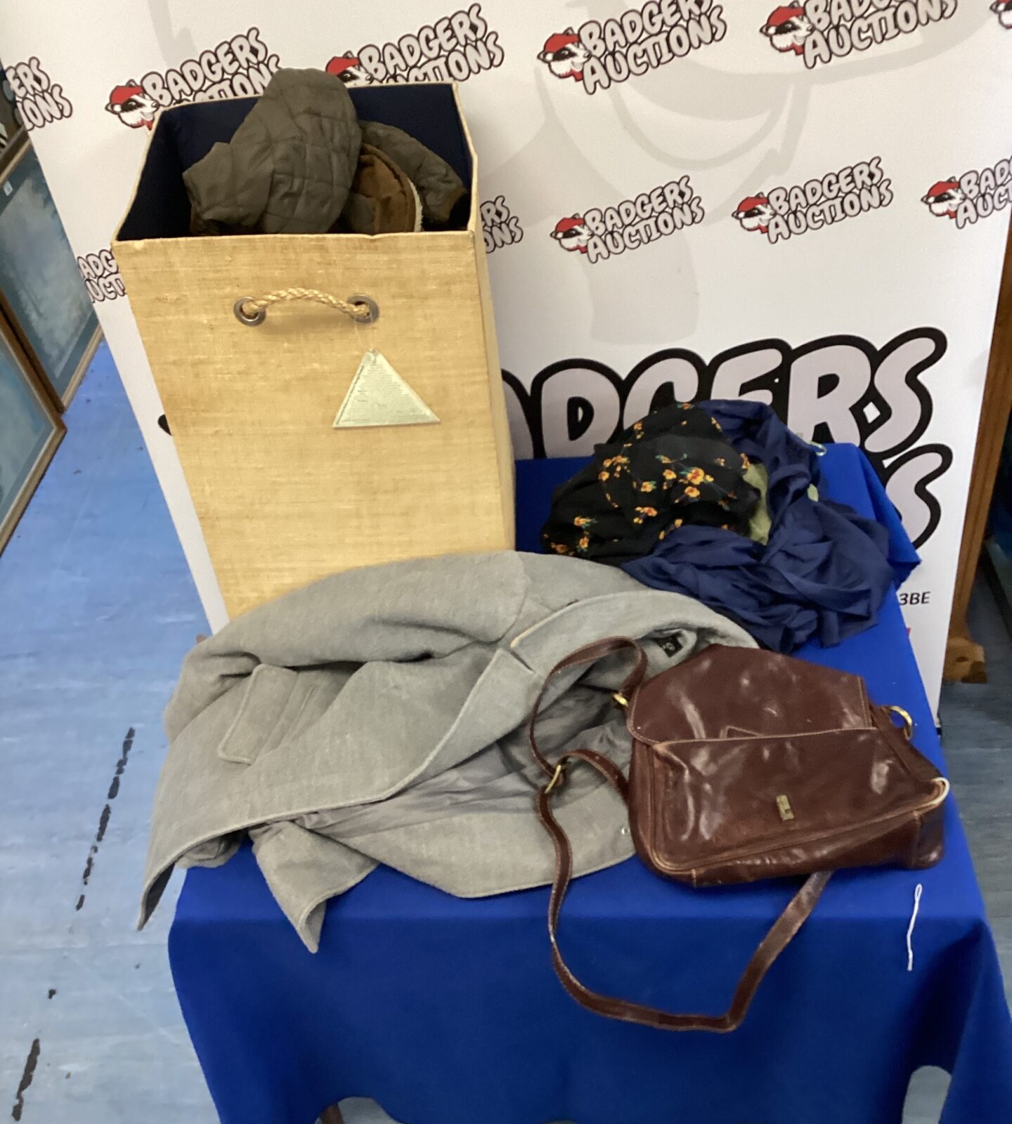 Mixed clothing lot bundle with various garments and textiles.