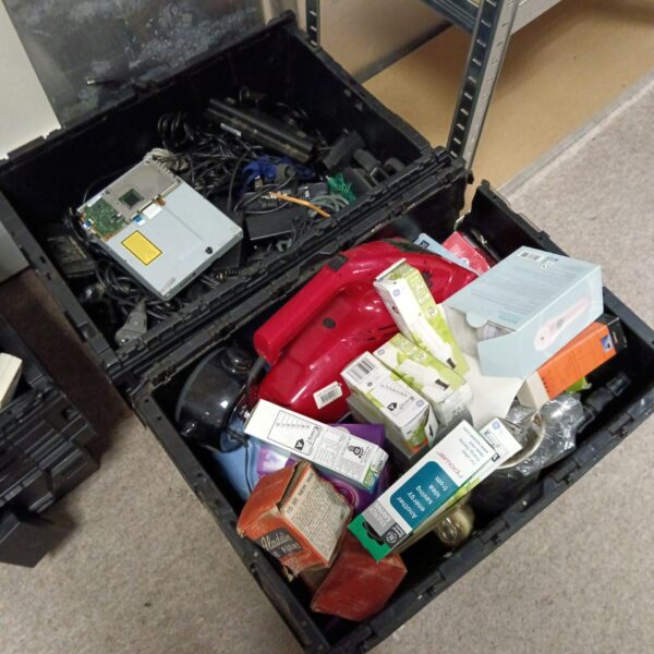 Overview of a mixed electronics lot with chargers and bulbs.