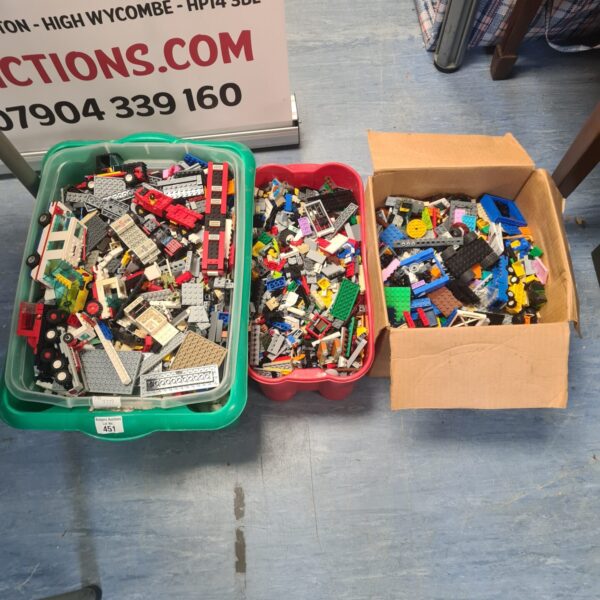 Three boxes filled with a large assortment of mixed Lego bricks.