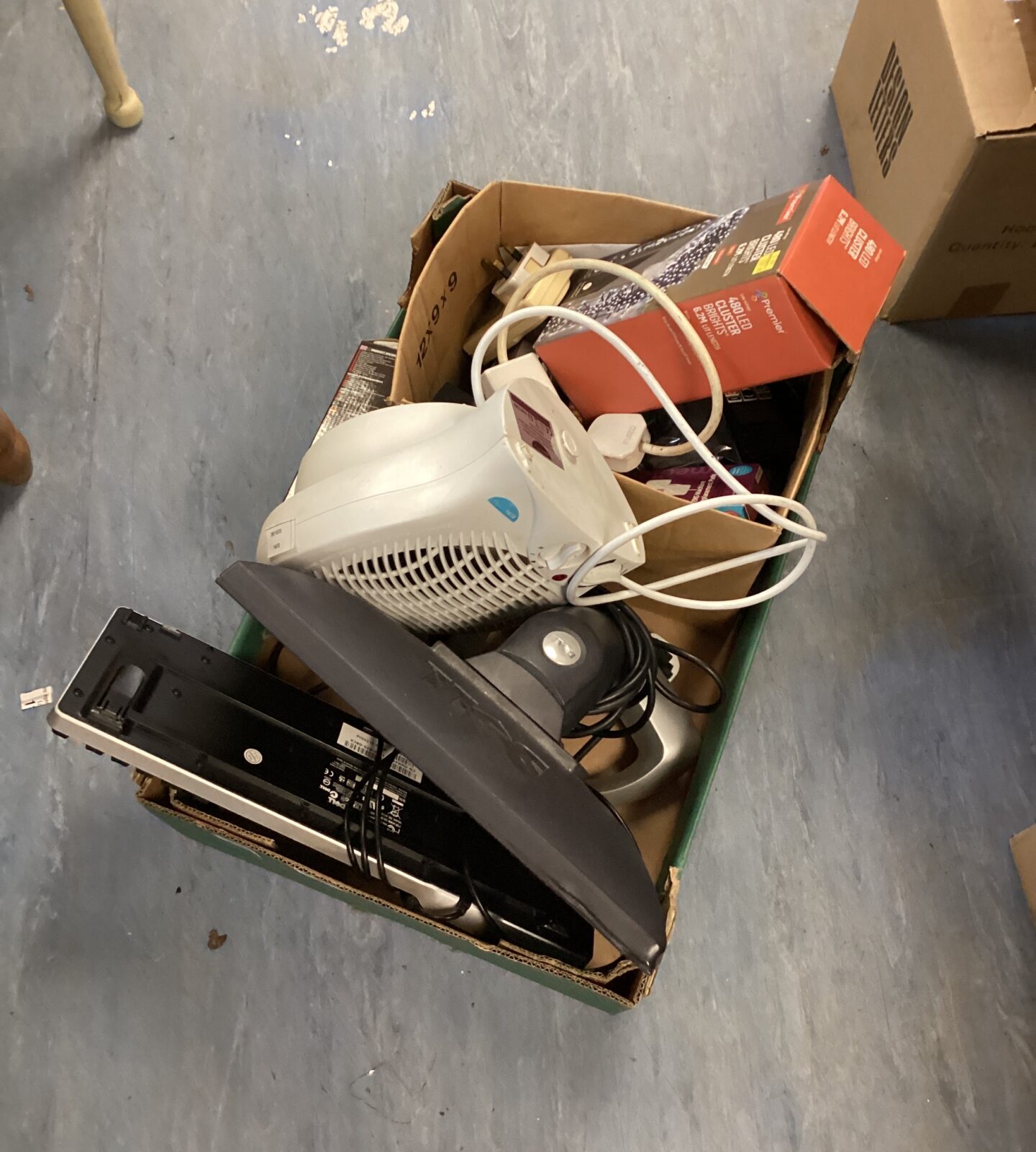 Mixed lot bundle with keyboard, heater fan, and Christmas lights.
