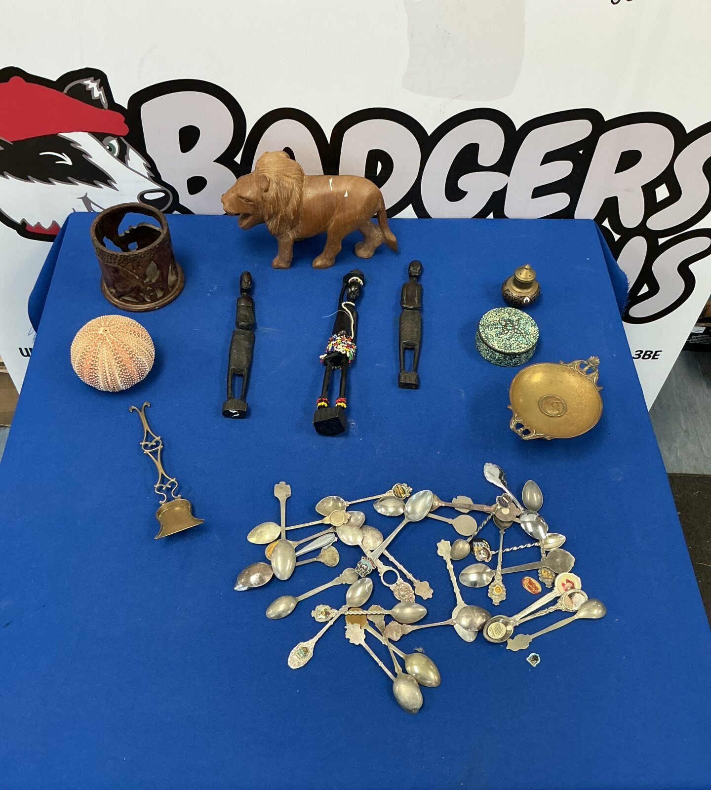 Mixed lot of vintage collectibles including spoons and a wooden lion.