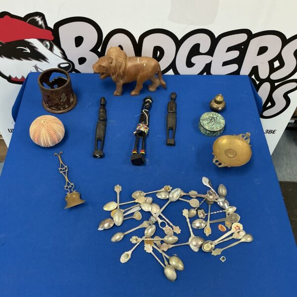 Mixed lot of vintage collectibles including spoons and a wooden lion.