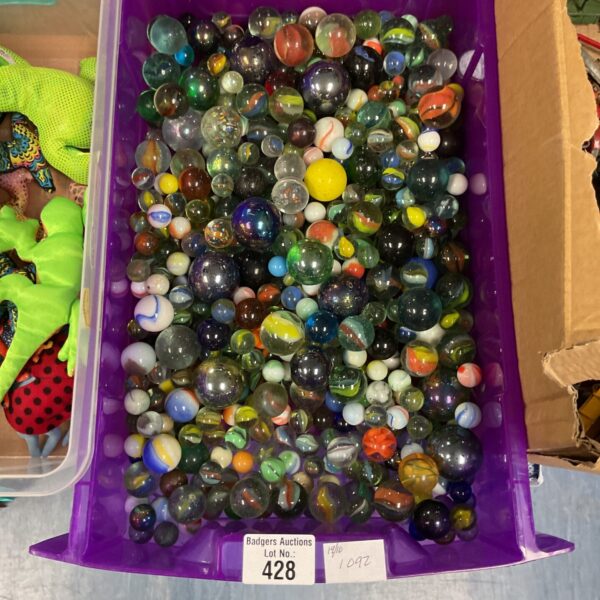 Colourful mixed marbles in a plastic container, vintage toy collection.