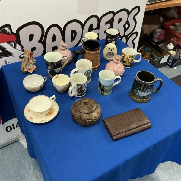 Mixed collection of vintage ceramic mugs and vases for home decor.