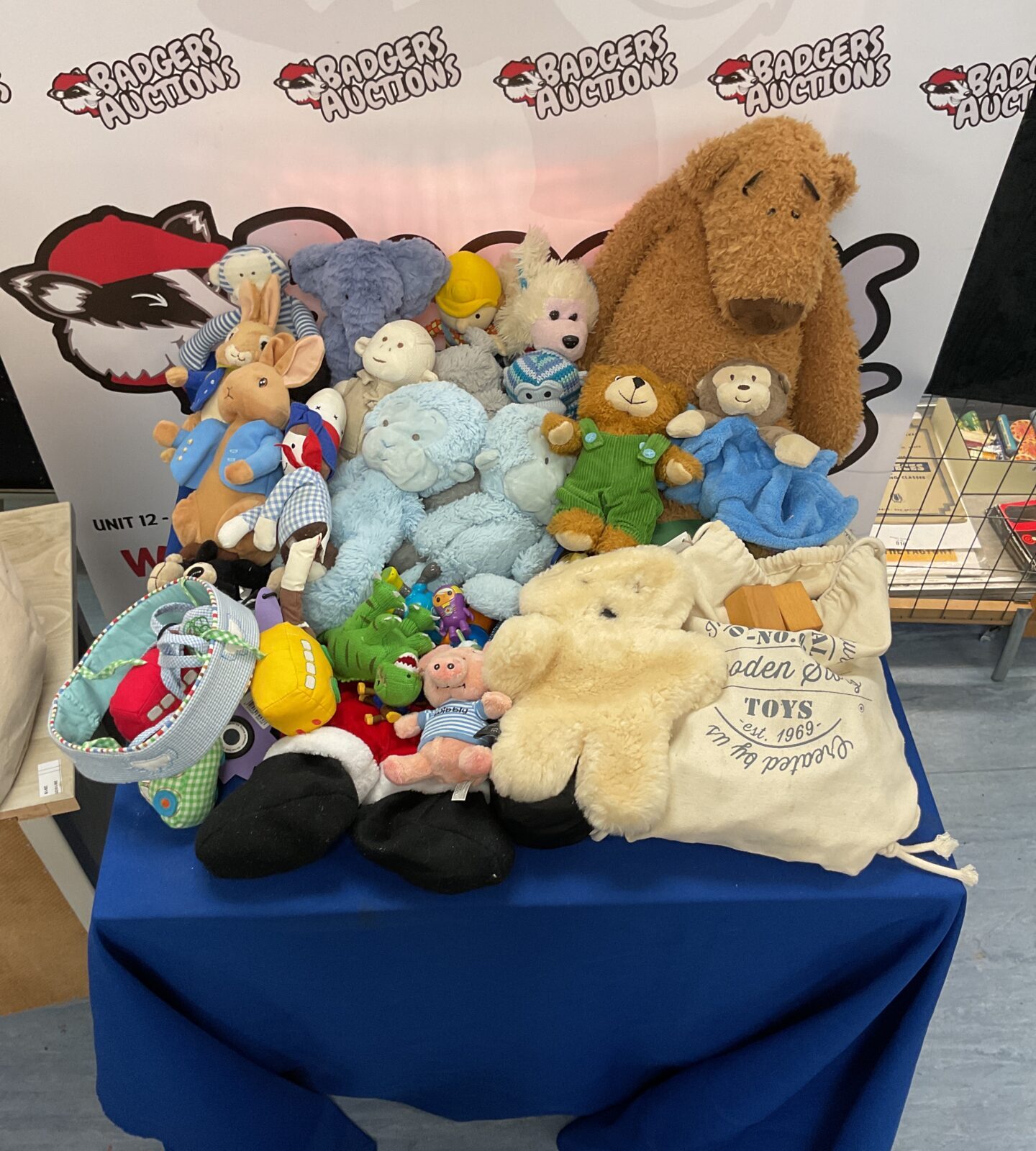 Mixed soft toy lot with wooden blocks for children's play.