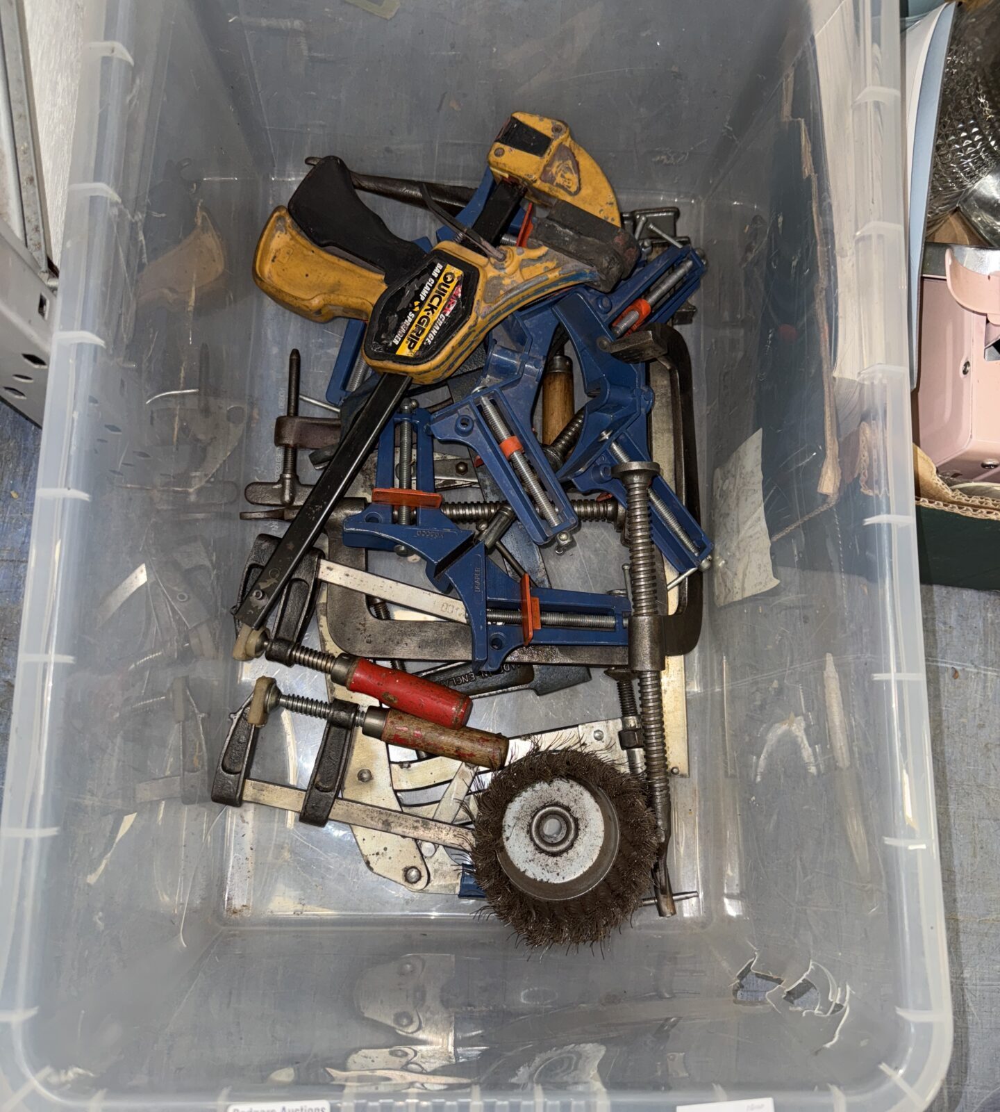 Mixed tool lot with clamps and a wire wheel for DIY projects.
