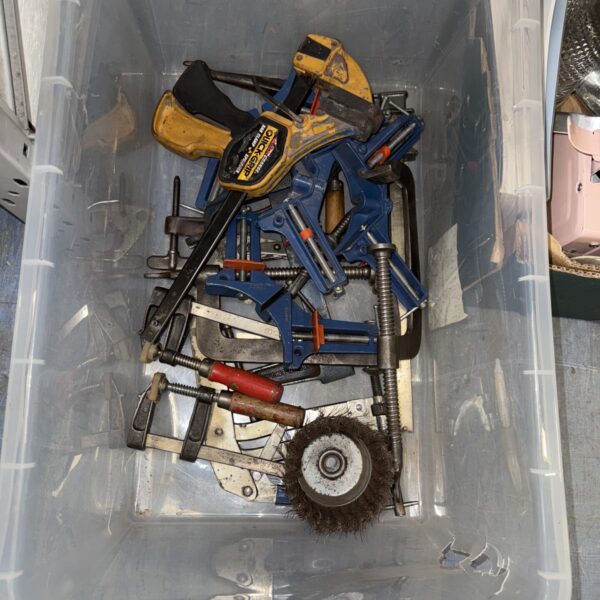 Mixed tool lot with clamps and a wire wheel for DIY projects.