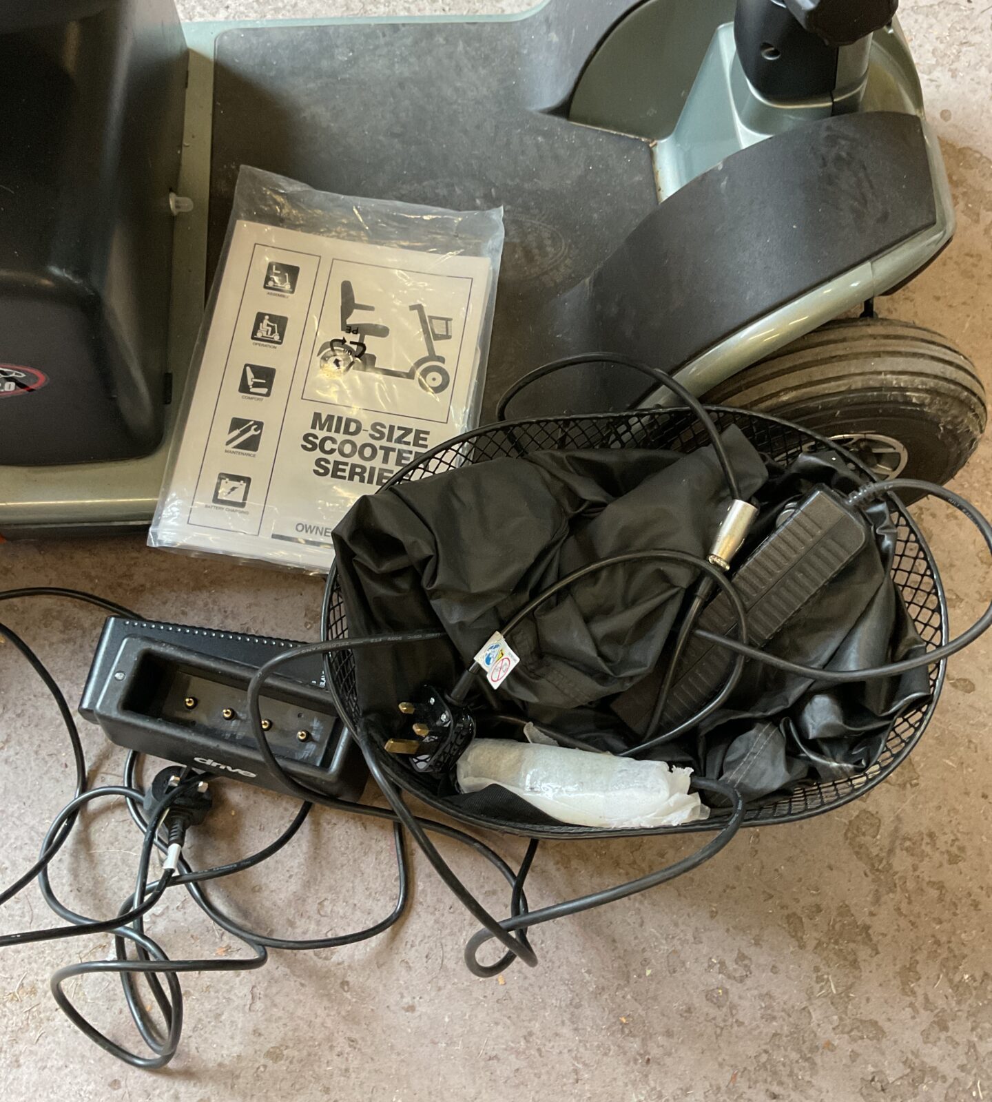 Close-up of the mobility scooter charger and basket.