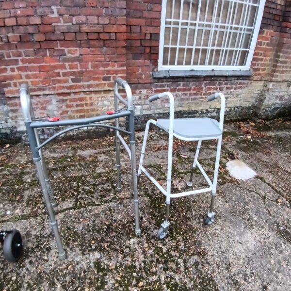 Silver mobility walker with a padded seat, a Zimmer frame.
