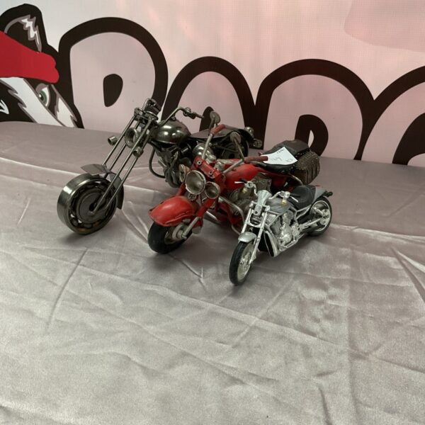 Lot of three detailed model motorcycles for collectors.