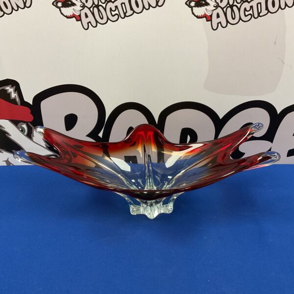 Vibrant red and clear Murano glass bowl with a swirling design.