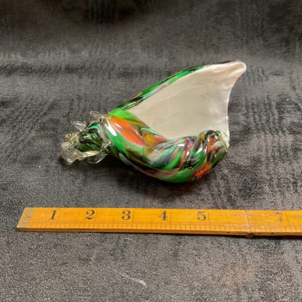 Vibrant Murano glass seashell sculpture with swirling colors.
