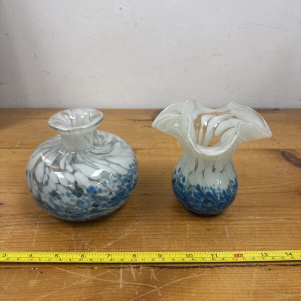 Colourful Murano glass vases with blue and white swirls.
