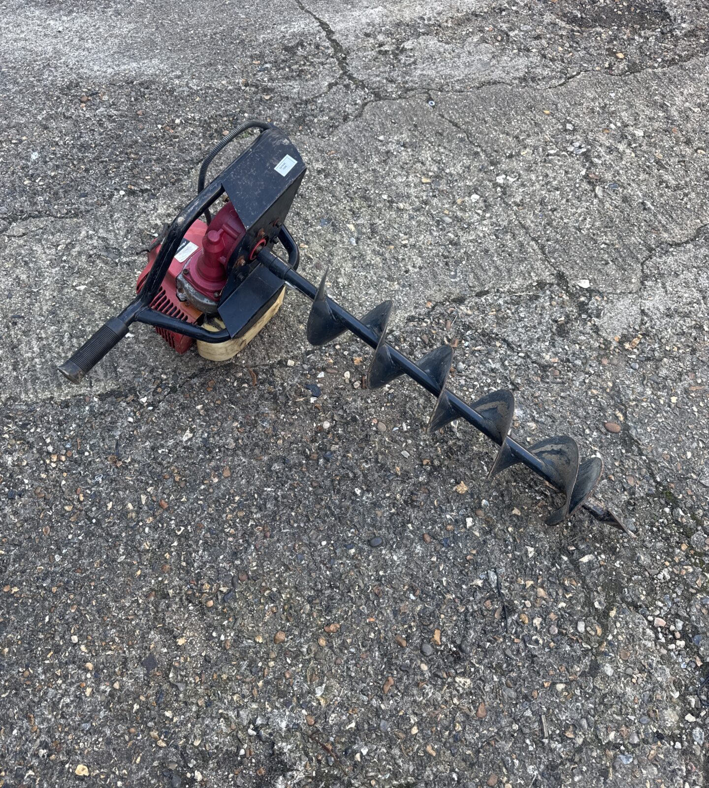 Nielsen petrol post hole borer for digging fence posts.