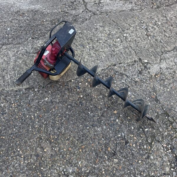 Nielsen petrol post hole borer for digging fence posts.