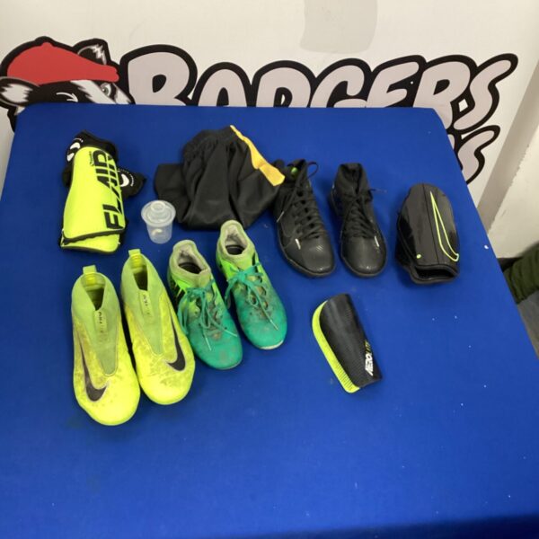Green Nike football boots with shin pads and shorts.