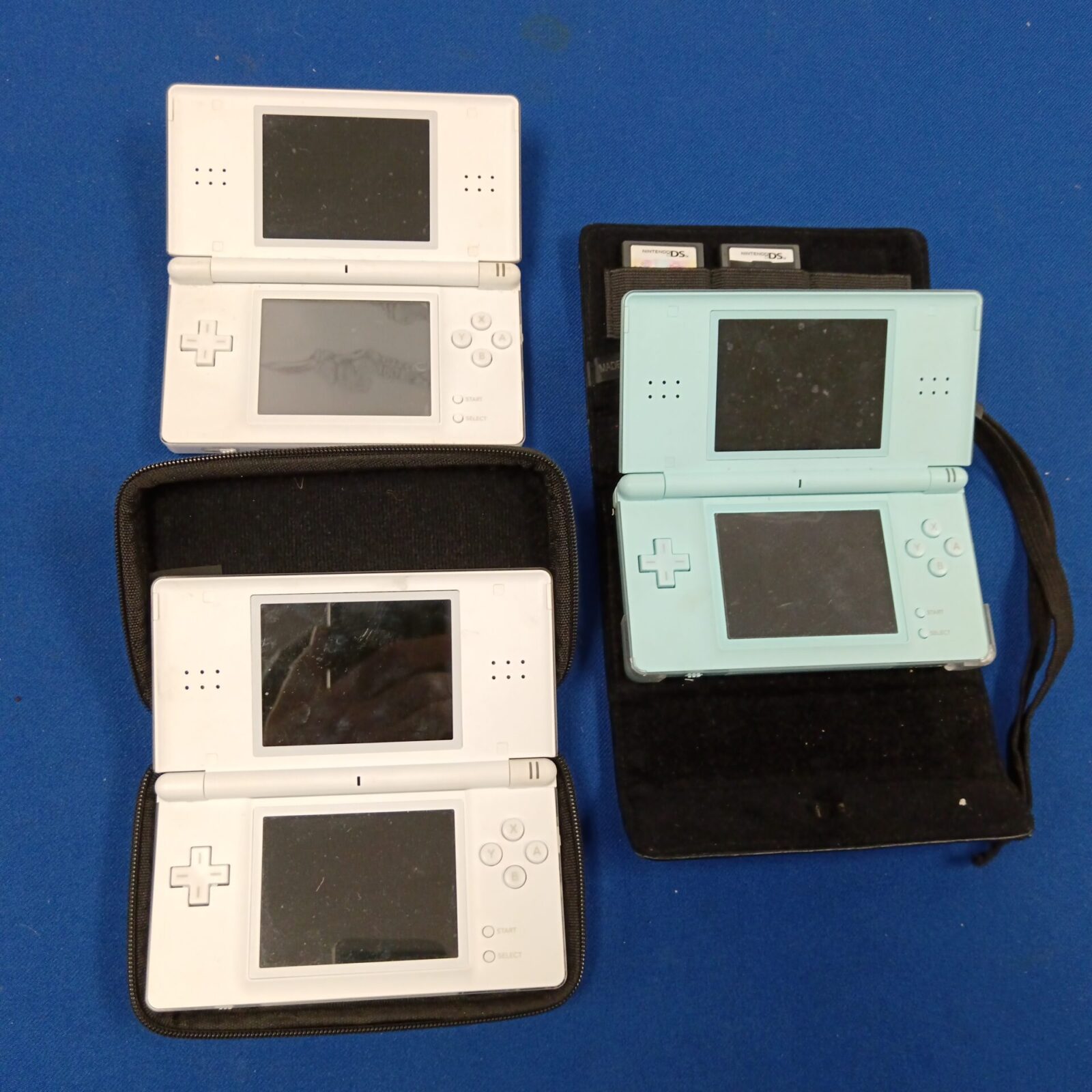 Lot of three Nintendo DS Lite consoles for retro gaming collectors.