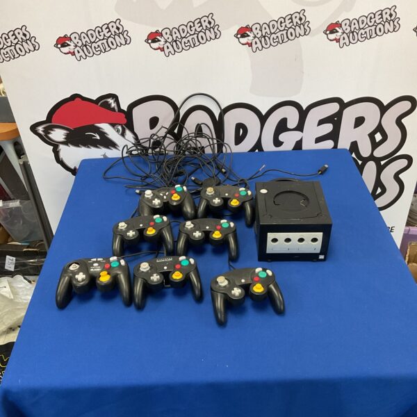 Nintendo GameCube console with seven controllers for retro gaming.