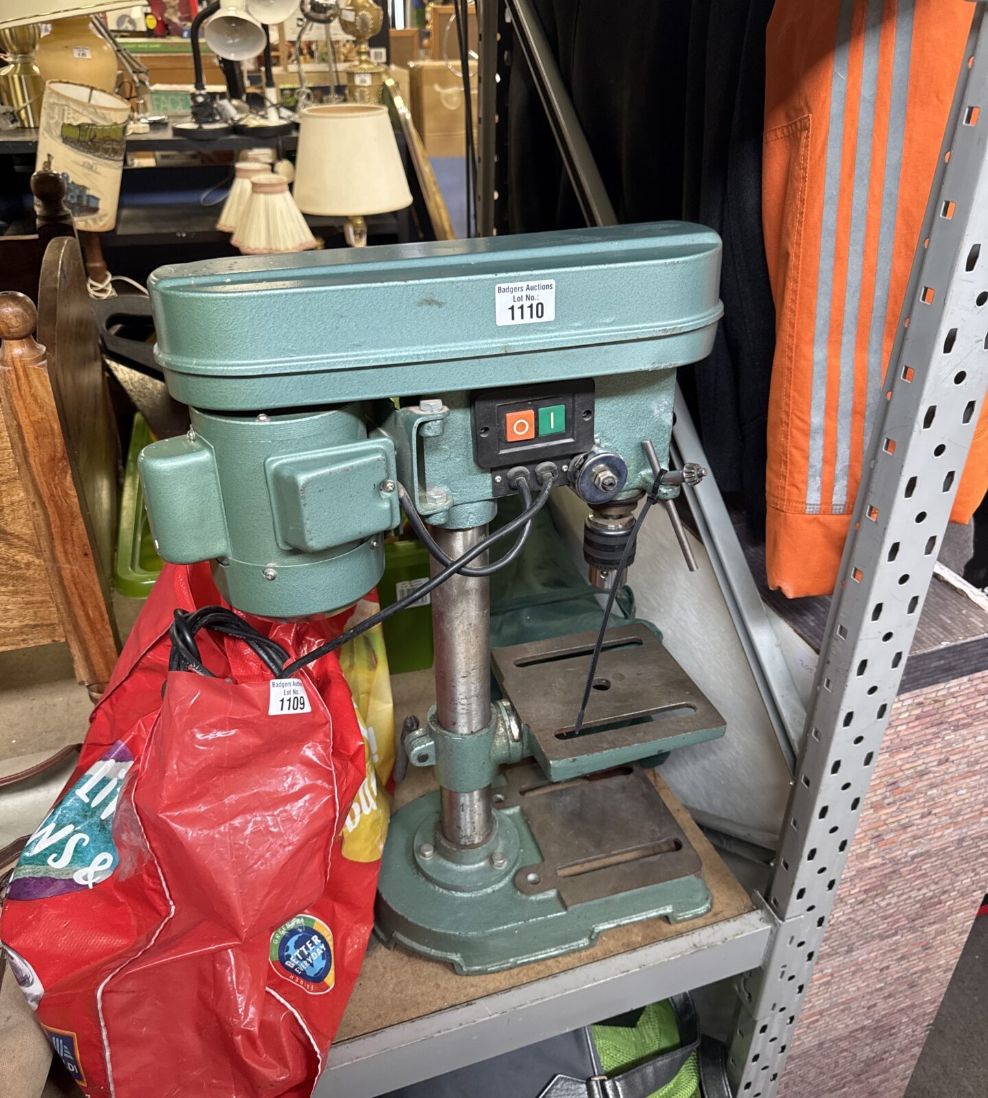 Vintage Nutool pillar drill in a workshop setting.