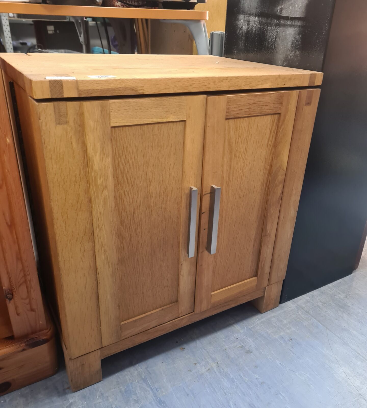 Front view of a solid oak CD cabinet with two doors.