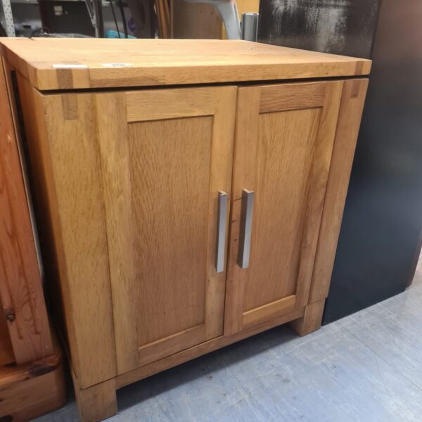 Front view of a solid oak CD cabinet with two doors.