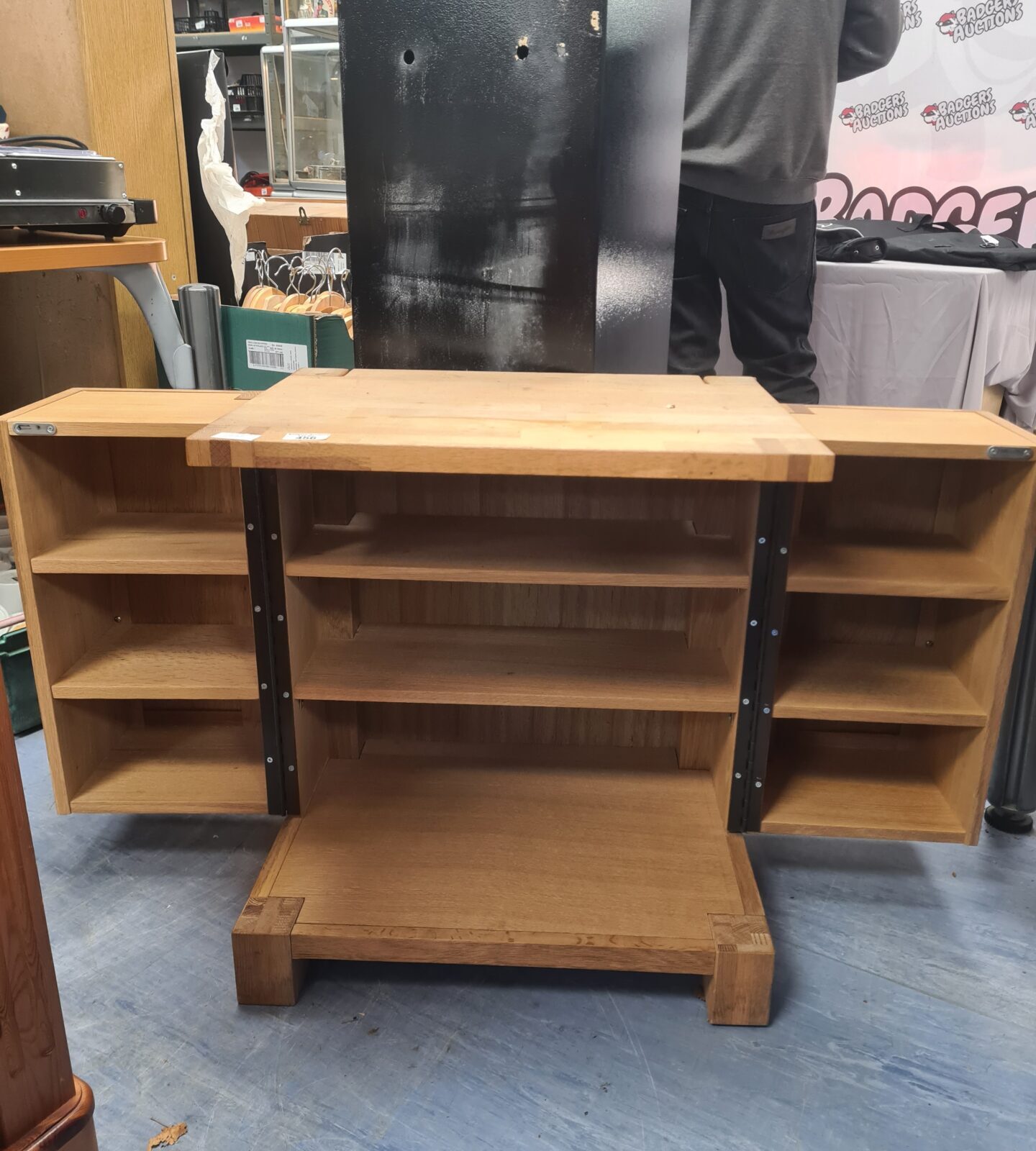 Side view of a wooden oak CD cabinet in good condition.