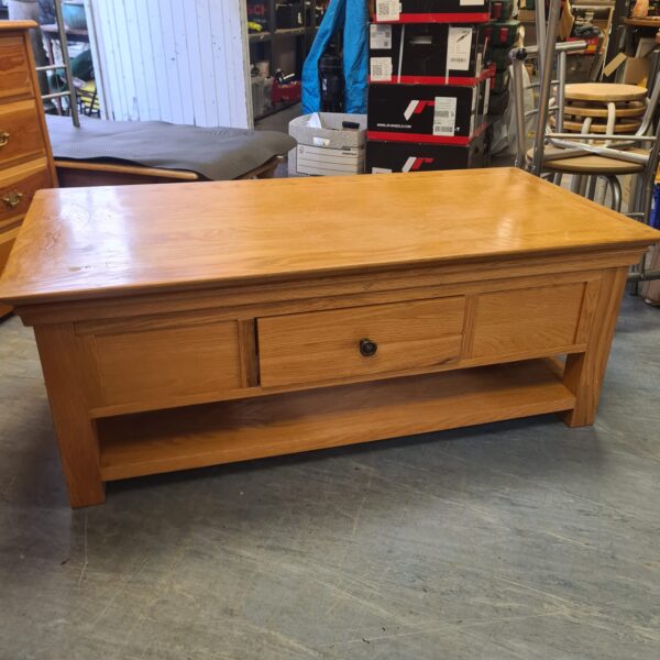 Rustic oak coffee table with a single drawer for storage.