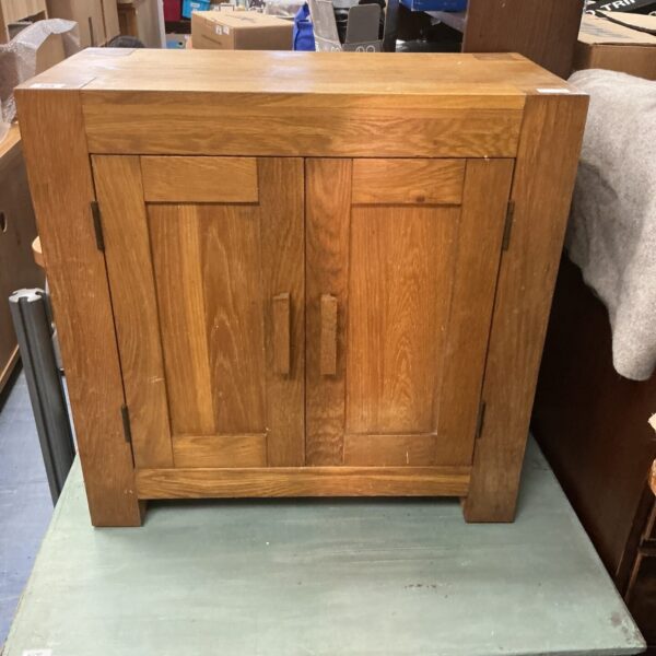 Front view of a vintage oak two-door cupboard.