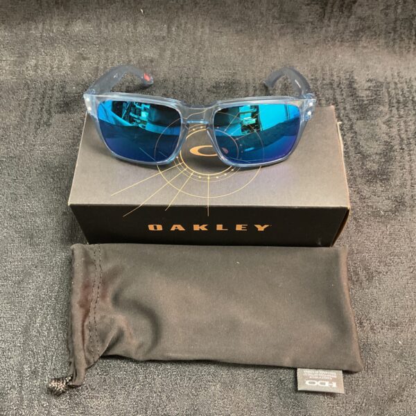 New Oakley kids sunglasses with vibrant blue lenses for sun protection.