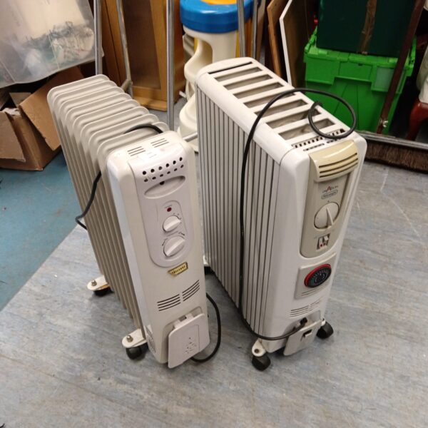 Two oil filled radiators, one with a dragon design, for home heating.