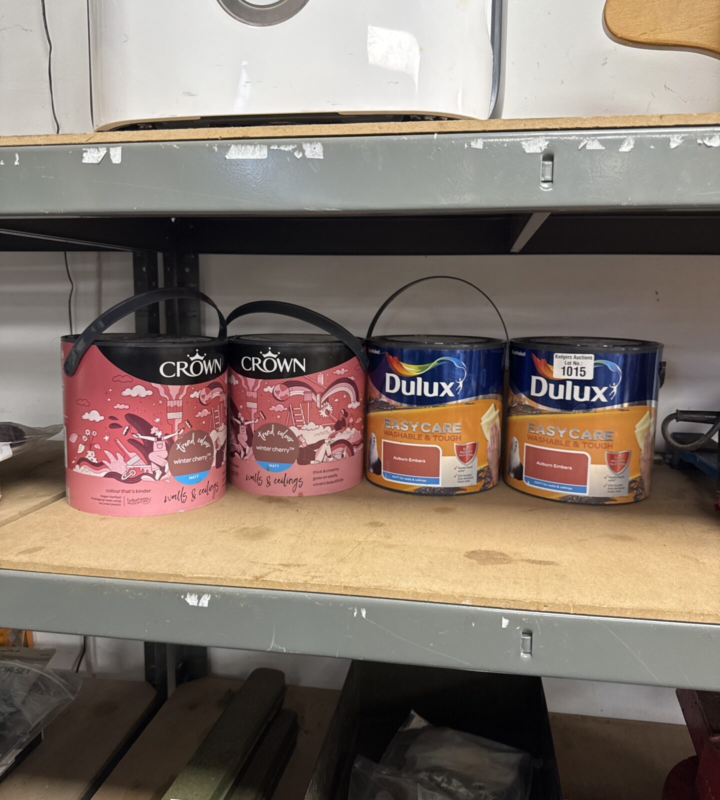 Collection of four unopened tubs of Dulux and Crown paint.