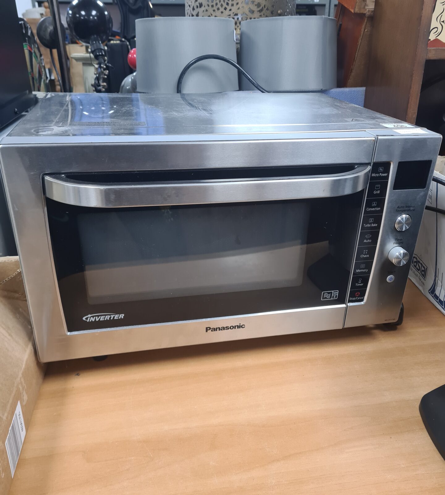 Stainless steel Panasonic inverter microwave oven for kitchen use.