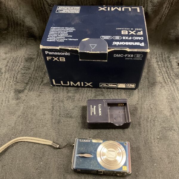 Panasonic Lumix DMC-FX8 digital camera with box and accessories.