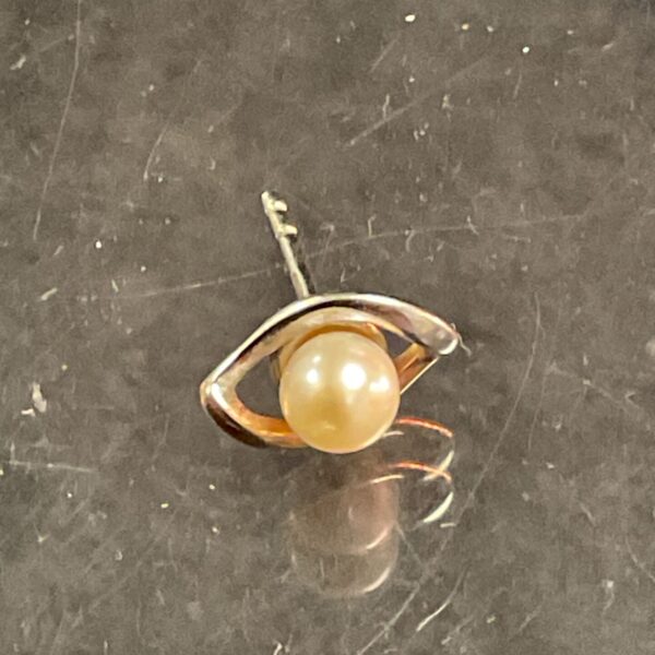 Close-up of a 9 carat gold and pearl stud earring.