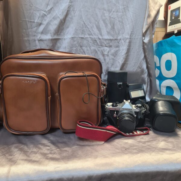 Vintage Pentax ME Super camera in a brown leather case.