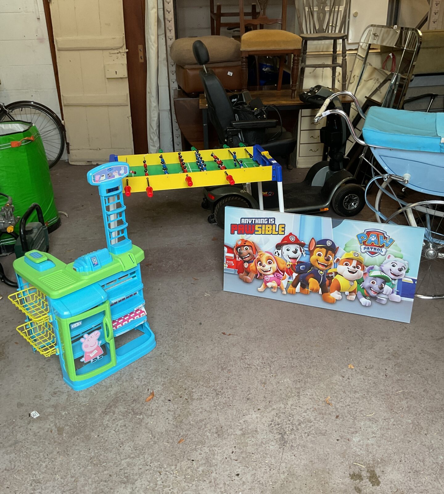 Colourful Peppa Pig play kitchen with football table and Paw Patrol canvas.