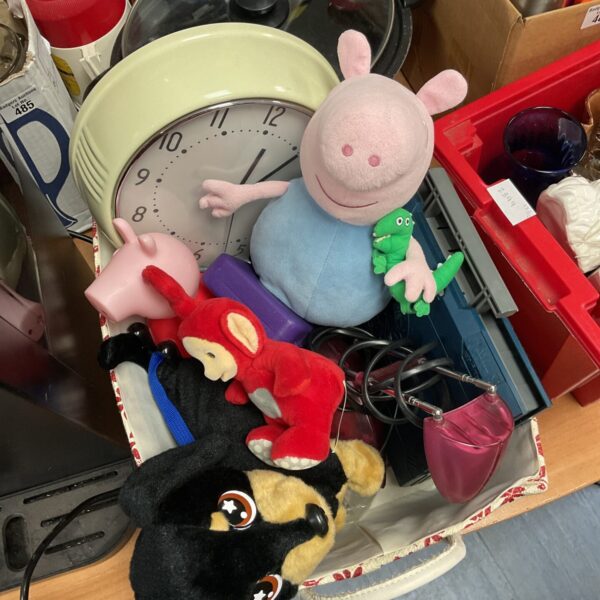 Mixed lot of Peppa Pig toys and a wall clock for children.