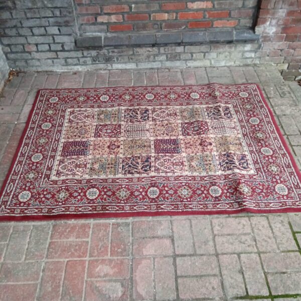 Intricate floral pattern on a vintage Persian style rug.
