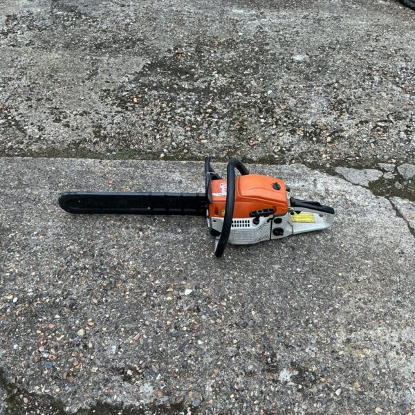 Front view of a used petrol chainsaw for garden and DIY tasks.