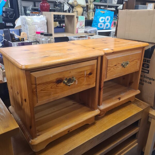 Pair of rustic pine bedside cabinets with brass handles.
