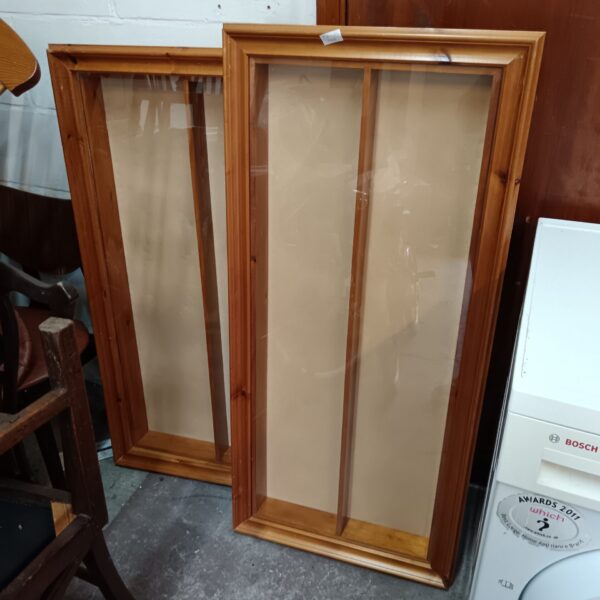 Vintage pine display cabinets with glass fronts for collectibles.