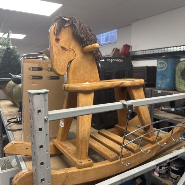 Vintage pine rocking horse, classic wooden toy for children.