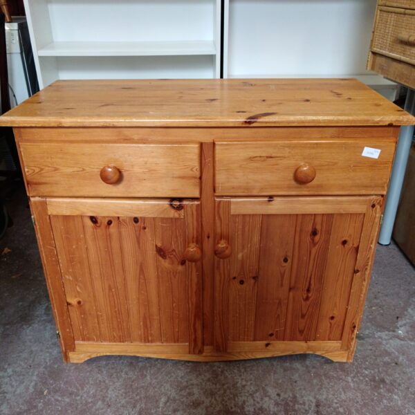 Vintage pine side cabinet with two drawers for storage.