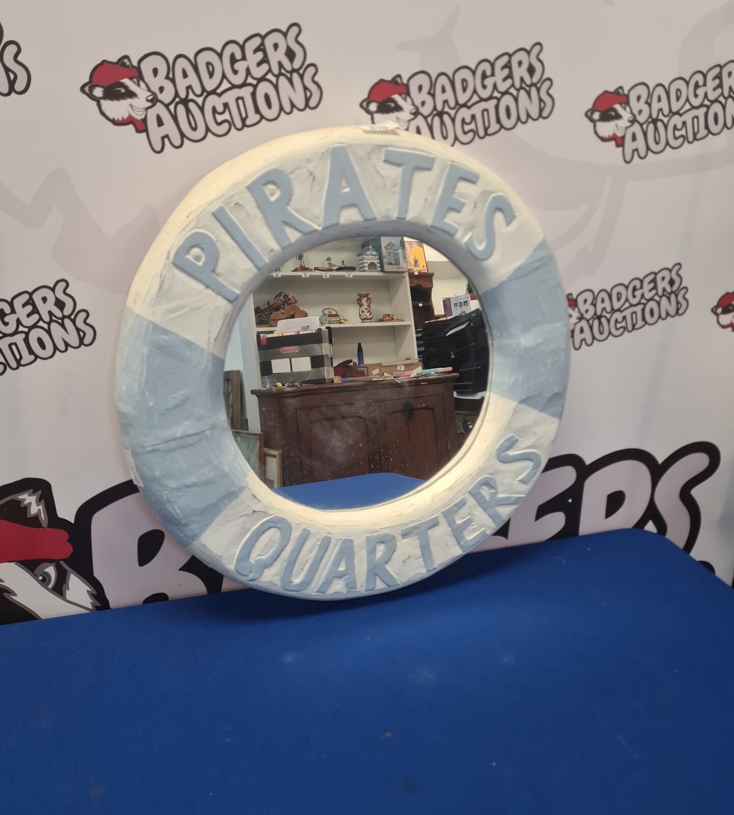 Detailed pirate ship hanging mirror for nautical decor.